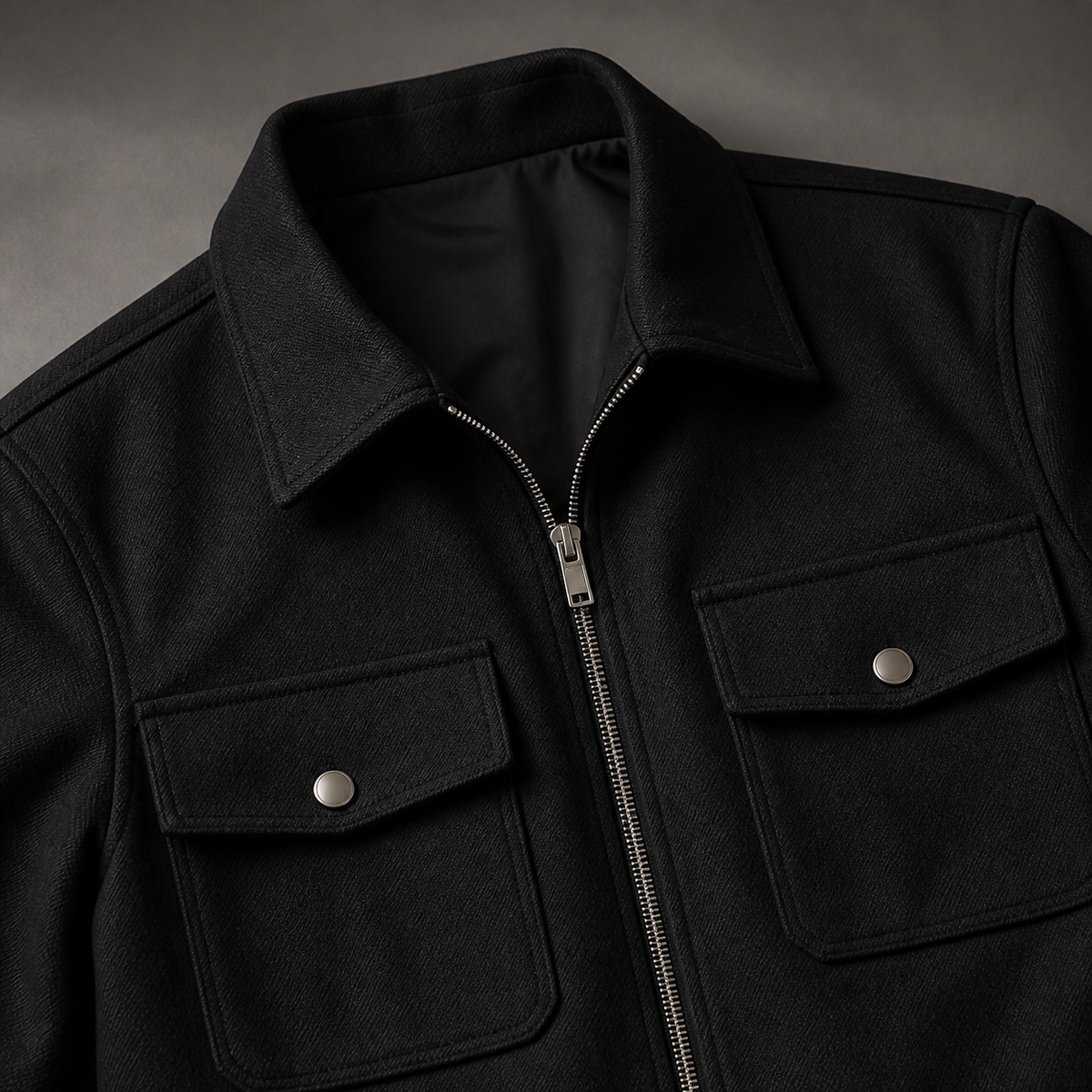 Close view of the black men's cargo jacket showing its neckline and distinctive surface texture.