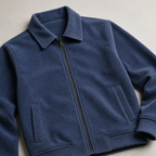 Close view of the haze blue men's corduroy jacket showing its neckline and distinctive surface texture.