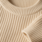 Close view of the light yellow men's crewneck sweater showing its neckline and distinctive surface texture.