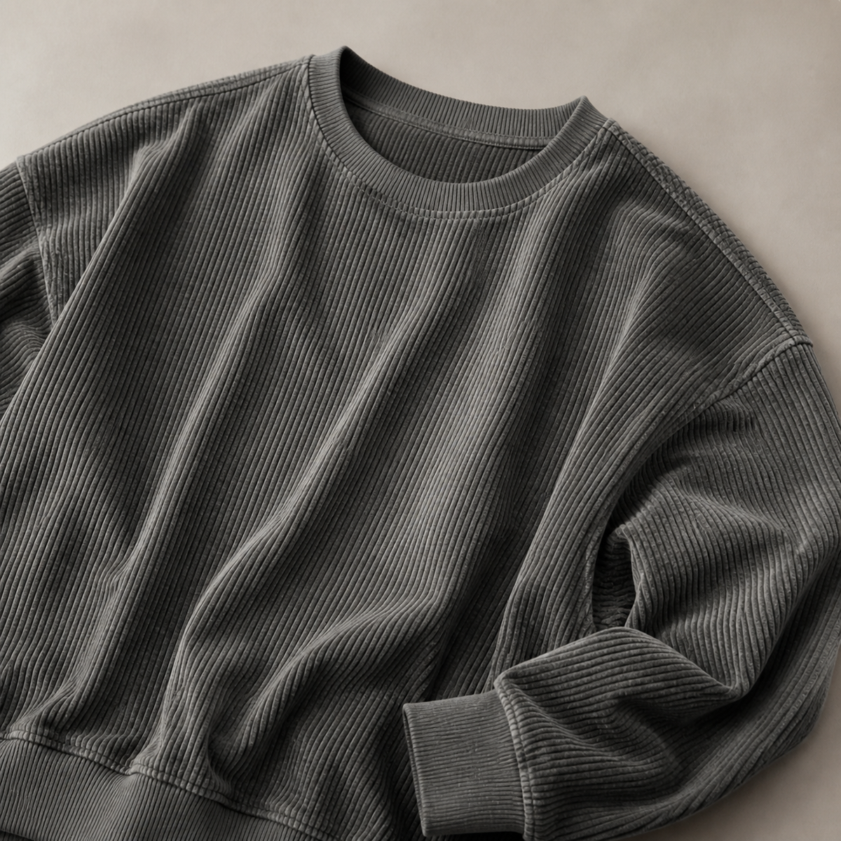 Close view of the grey men's crewneck sweatshirt showing its neckline and distinctive surface texture.