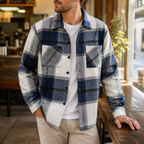 Man wearing the blue men's flannel shirt jacket in a softly lit US cafe.