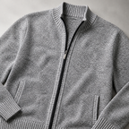 Close view of the light grey men's knit cardigan jacket showing its neckline and distinctive surface texture.