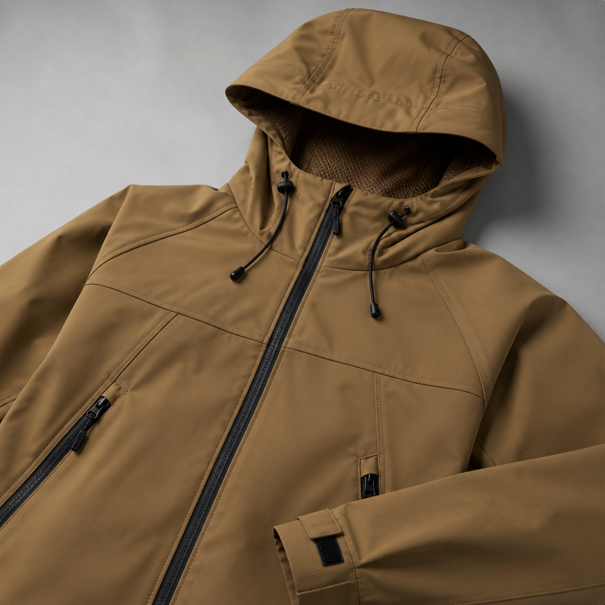 Close view of the khaki men's outdoor jacket showing its neckline and distinctive surface texture.