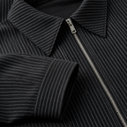 Close view of the black men's pinstripe jacket showing its neckline and distinctive surface texture.