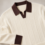 Close view of the apricot men's polo sweater showing its neckline and distinctive surface texture.