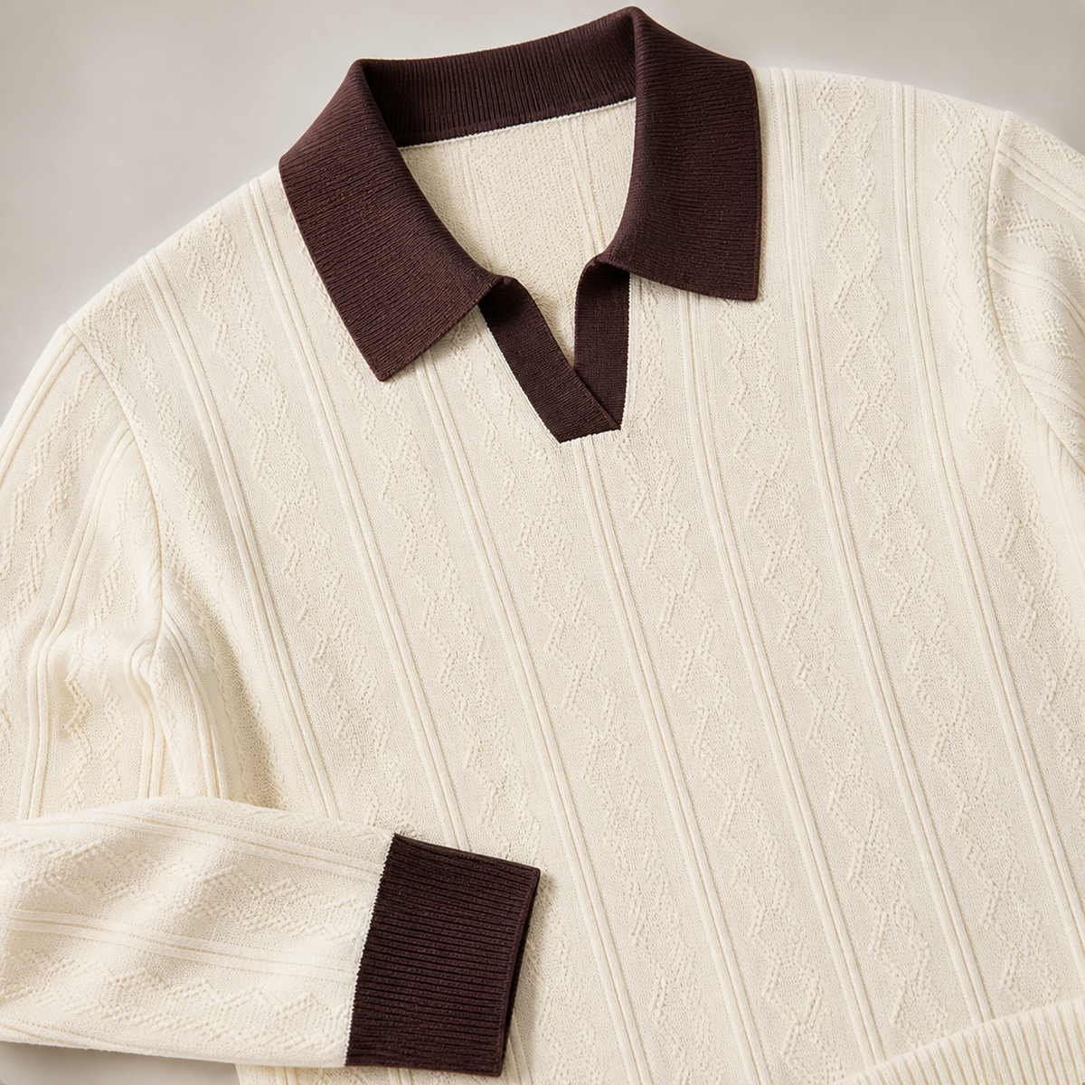 Close view of the apricot men's polo sweater showing its neckline and distinctive surface texture.