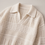 Close view of the apricot men's polo sweater showing its neckline and distinctive surface texture.