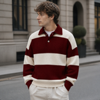 Man styling the red men's polo sweater on a quiet US city street.