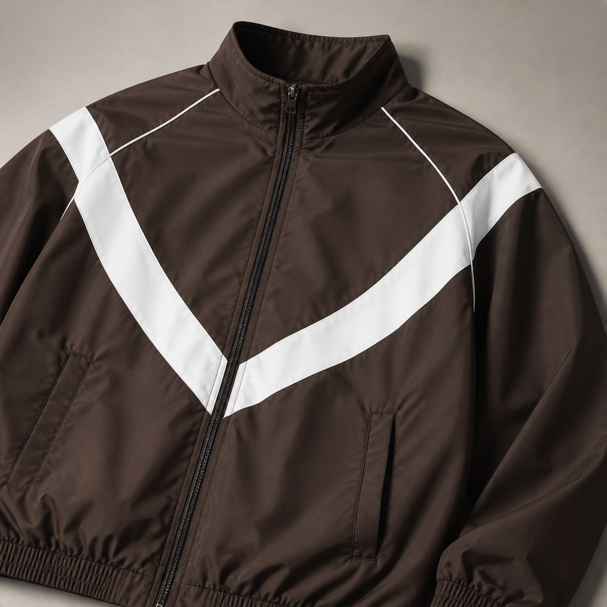 Close view of the coffee color men's windbreaker jacket showing its neckline and distinctive surface texture.
